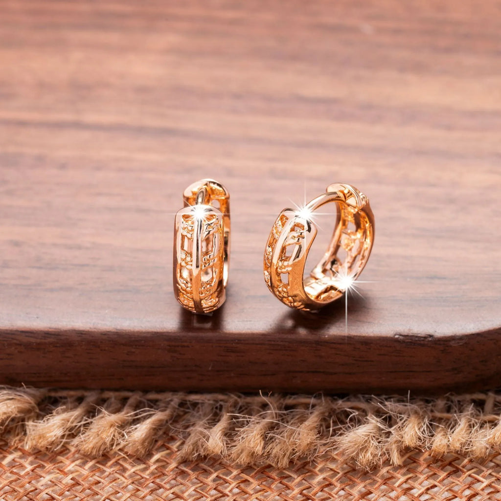 Hollowed-out copper earrings in heart and leaf shapes with a rose gold finish.