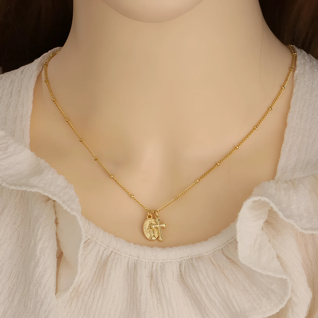 Gold Virgin Mary cross necklace with geometric design on chain