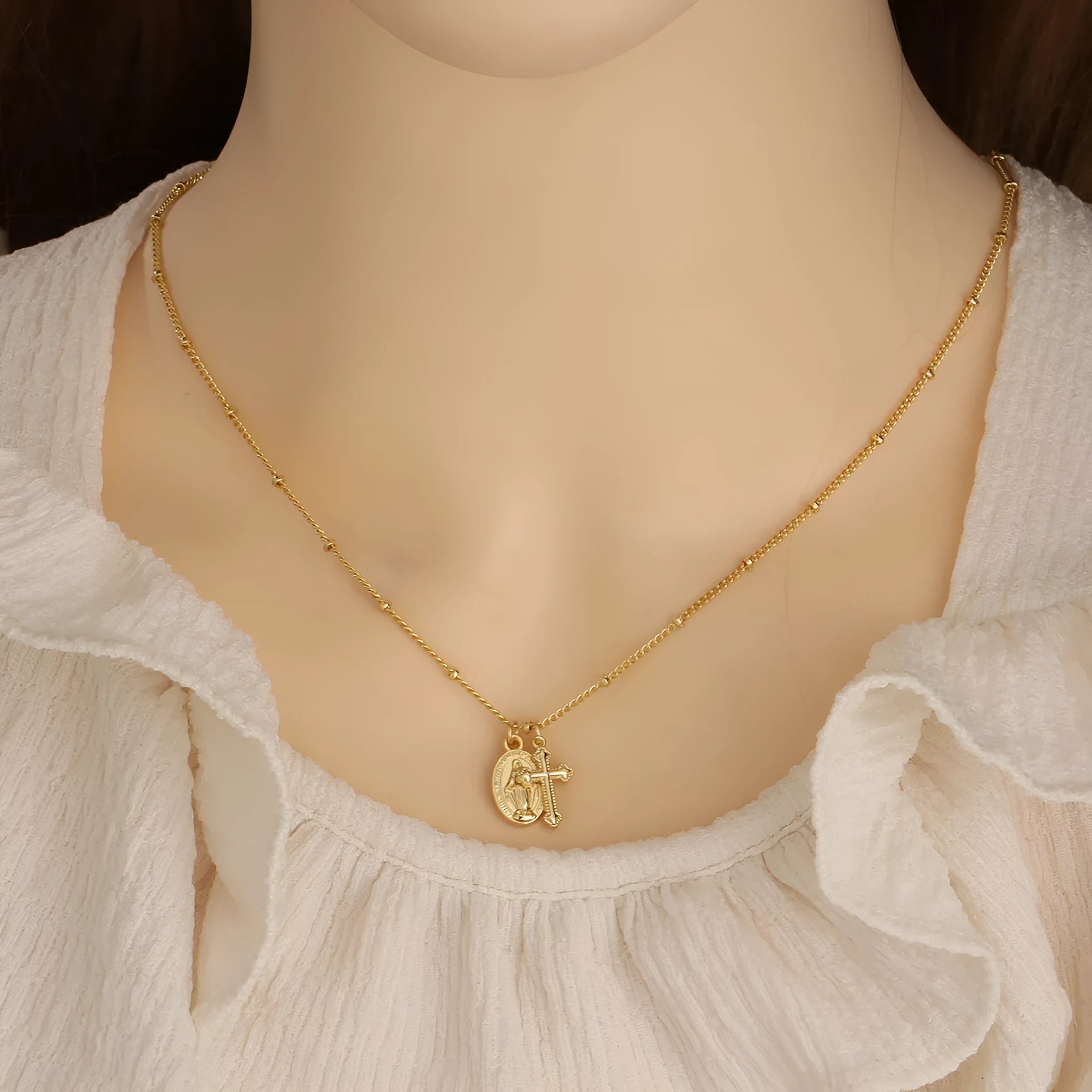 Gold Virgin Mary cross necklace with geometric design on chain