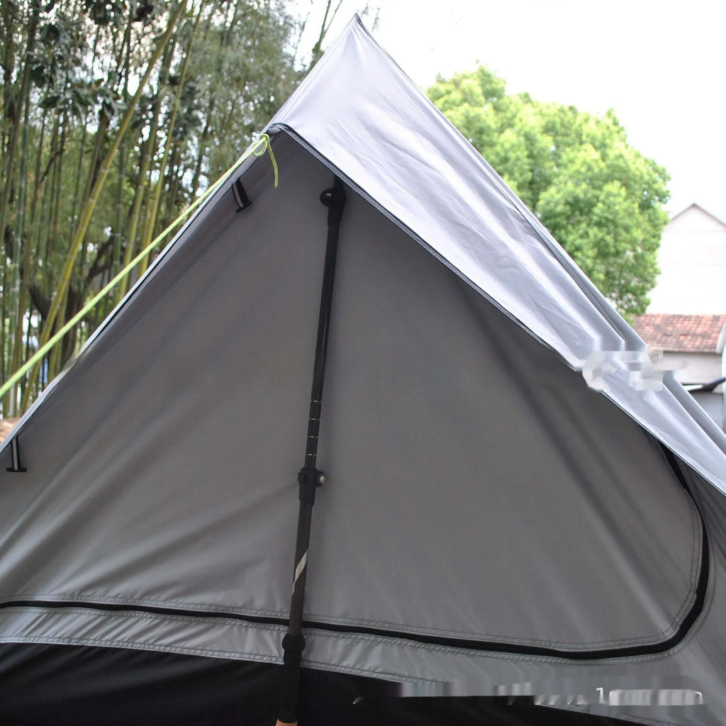 Brown A-line cabin tent pitched using hiking poles with aluminium ground nails and fluorescent wind ropes