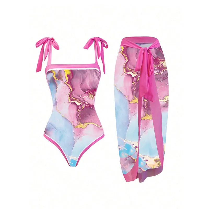 Pink one-piece printed sheath swimsuit for women with sun protection and matching skirt for beach or pool