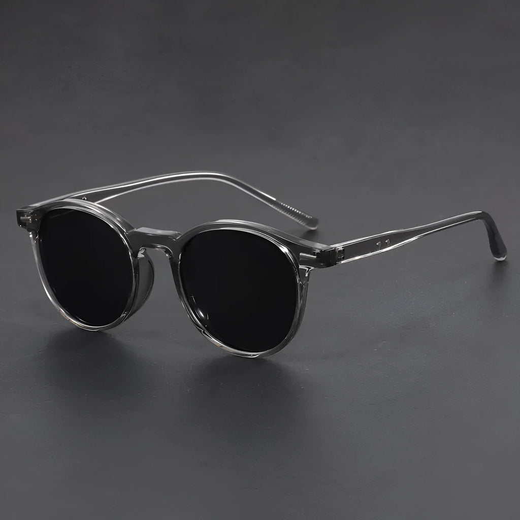 Retro oval frame sunglasses with polarised grey lenses in various frame colours on a light background