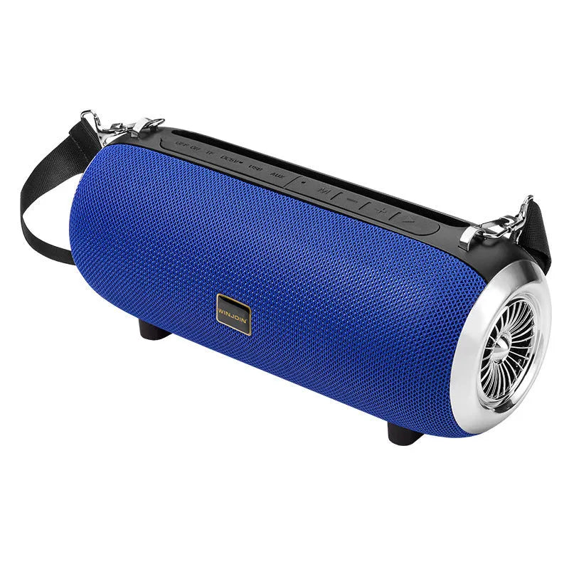 F666 portable fabric Bluetooth speaker with shoulder strap on a table next to a phone
