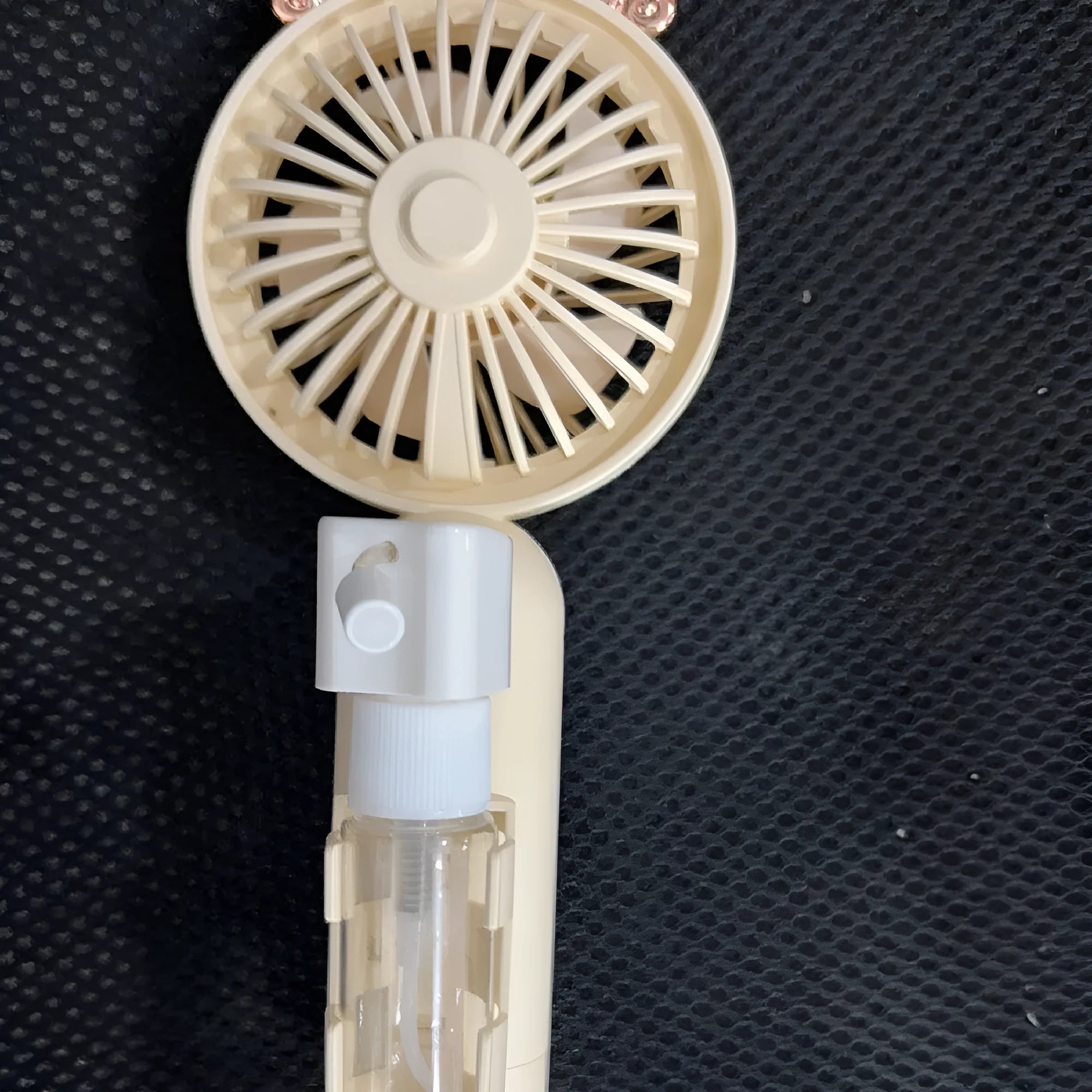 Colourful plastic handheld personal fan with nozzle, shown with USB charging cable