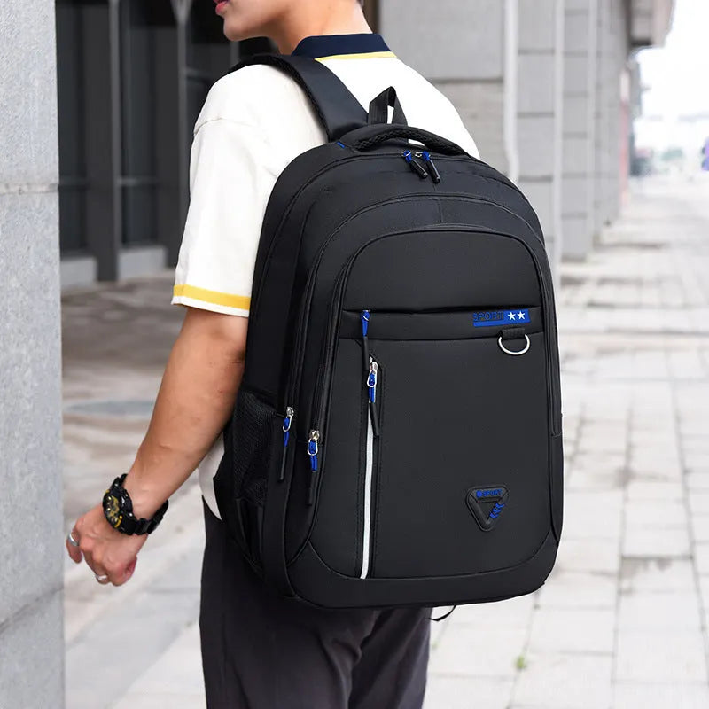 Men's Oxford cloth schoolbag with letter pattern in black, blue, green, or red colours showing air pillow belt system