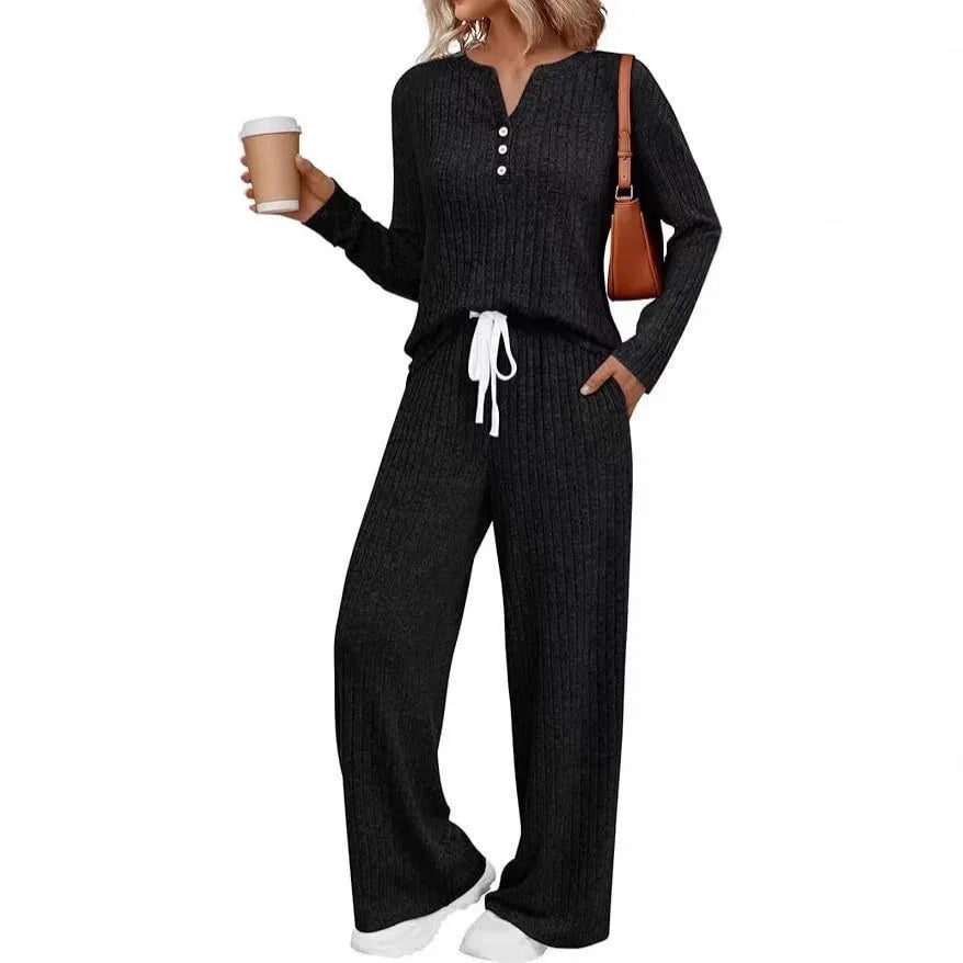 Knitted V-neck striped long coat with long sleeves, pockets, and a lace-up detail on a hanger.