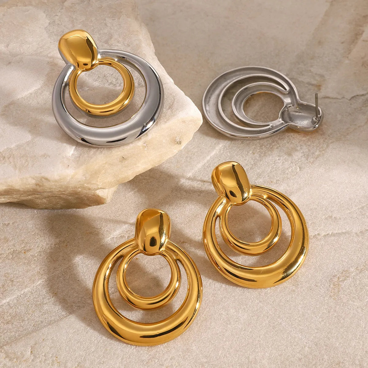 Gold tone geometric round stud earrings with hollow double-layer design on titanium steel backing