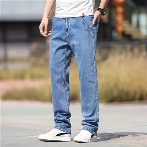 Man wearing smoky grey straight leg jeans with low waist and zipper fly.