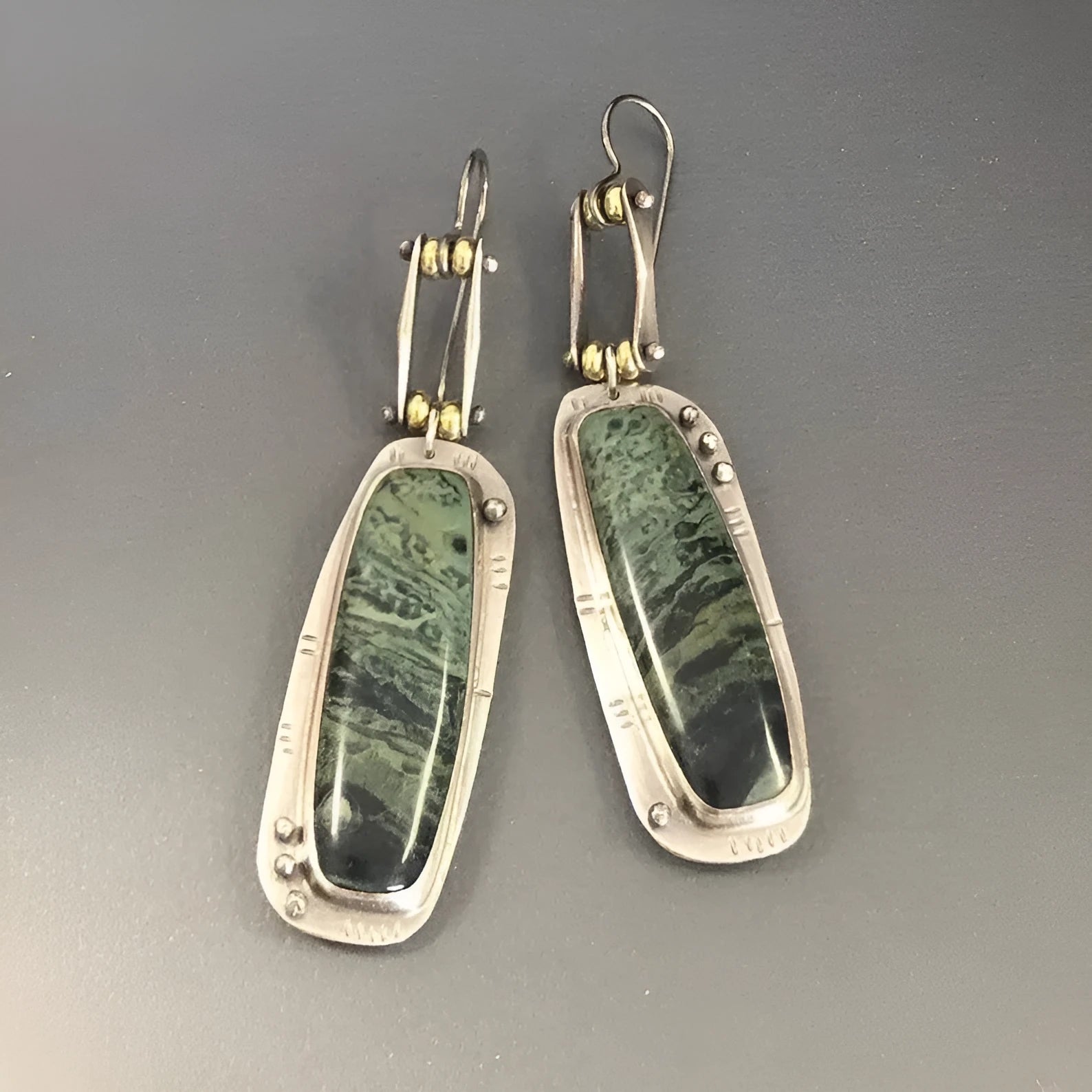 Geometric two-colour marble pattern alloy earrings on a white background.
