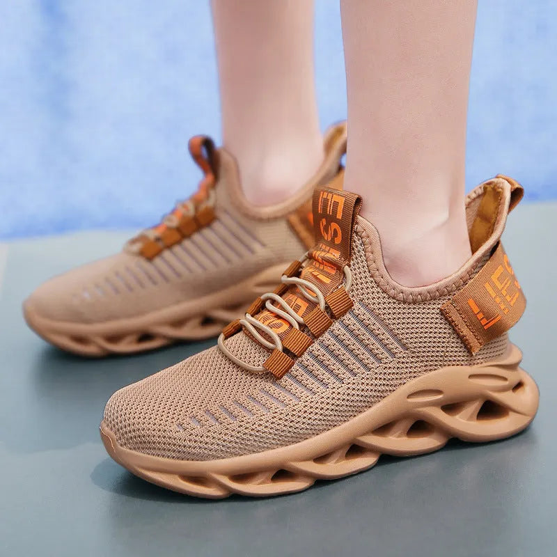 Kids' black coconut sneakers with Velcro strap, fabric upper, and textured EVA sole.