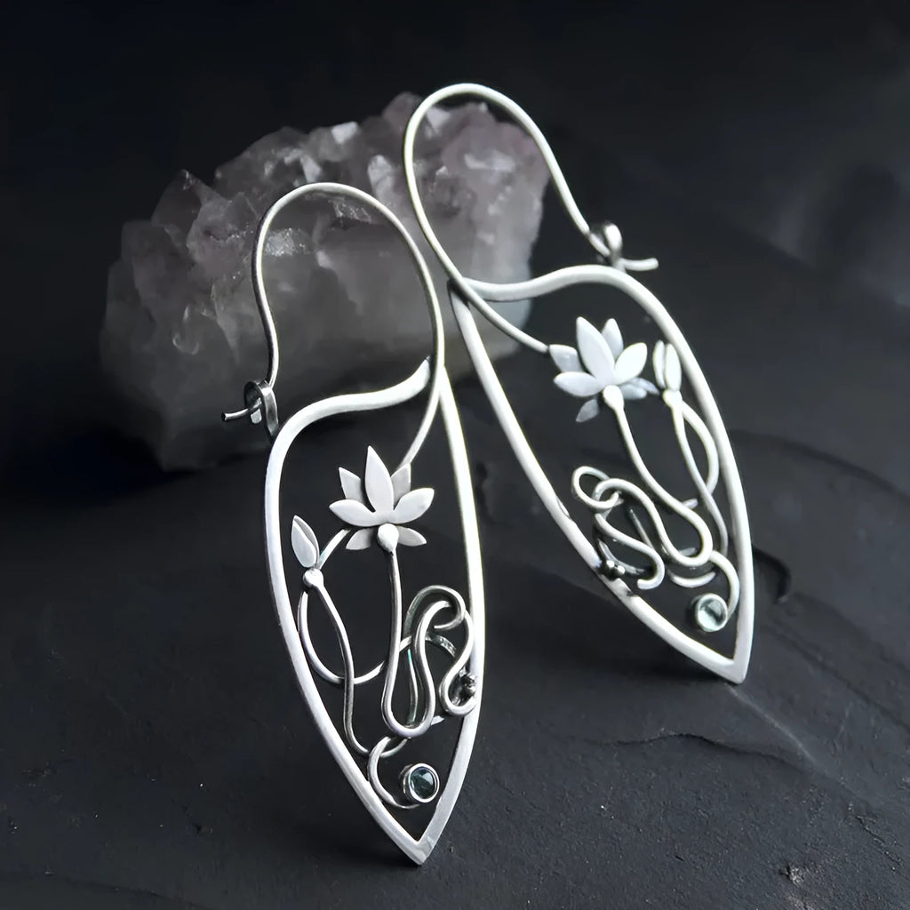 Silver rhinestone earrings with geometric lotus vine design on alloy base