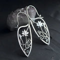 Silver rhinestone earrings with geometric lotus vine design on alloy base