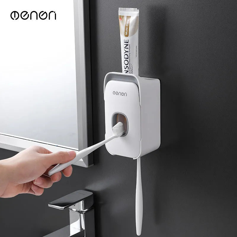 Automatic wall-mounted toothpaste dispenser in blue colour on a bathroom wall.