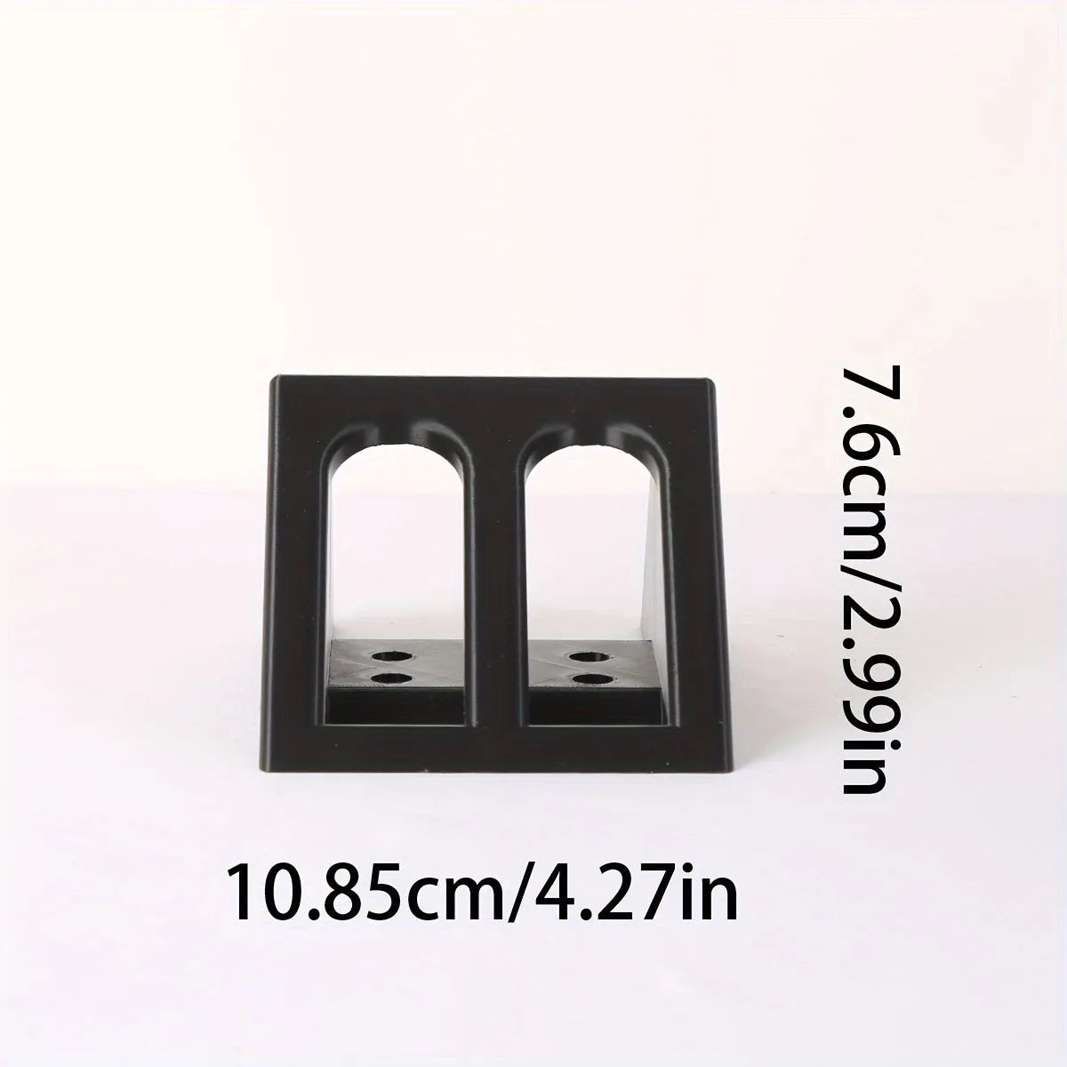 Black punk-style plastic pistol stand measuring 10.85 by 7.6 centimetres