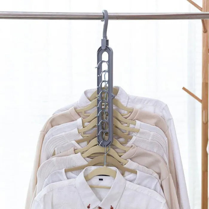 Plastic clothes hanger with rotating hook in pink and green colours on a rail.