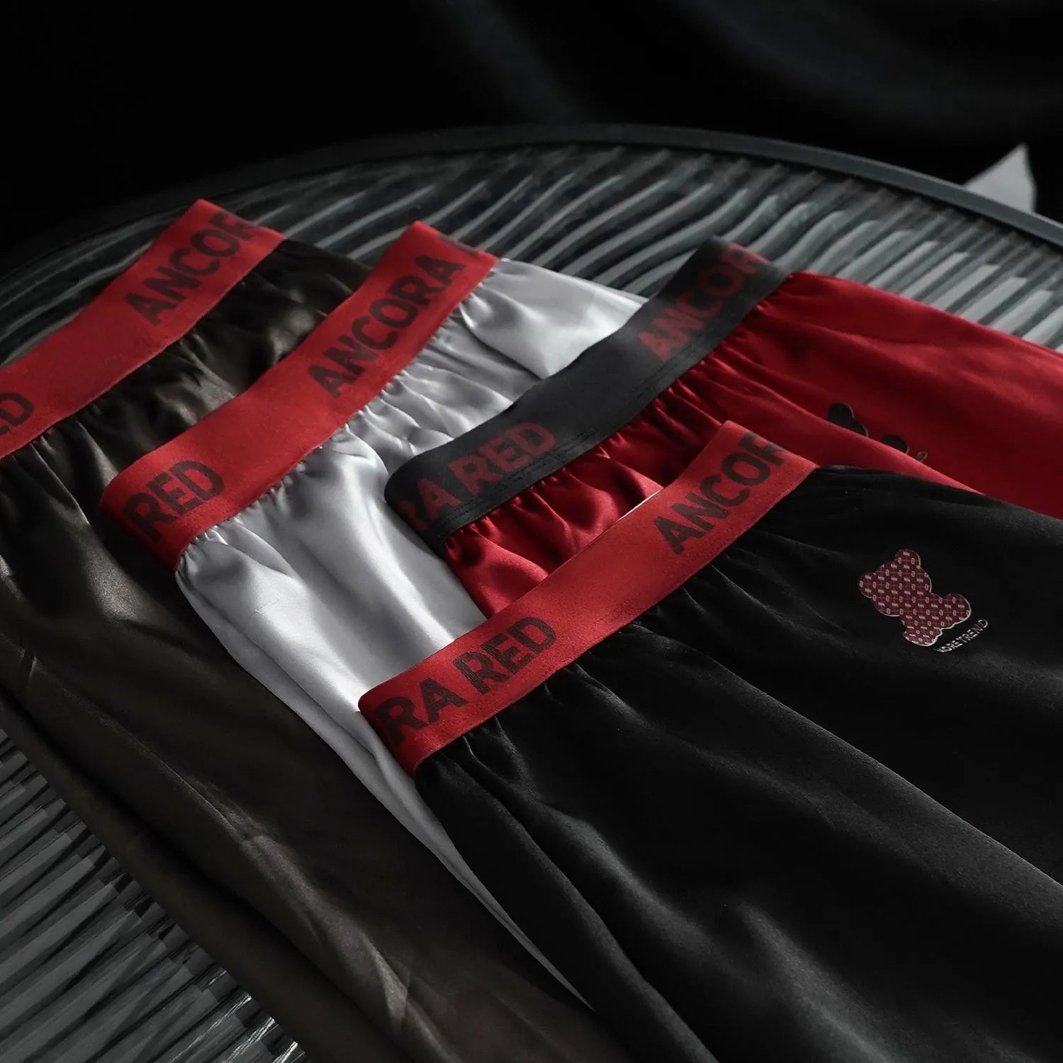 Men's solid colour boxer briefs on a mid-waist, showing the knitted polyester fabric in a black colour option.