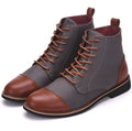 Men's black leather boots with metal belt buckle details and a rubber sole.