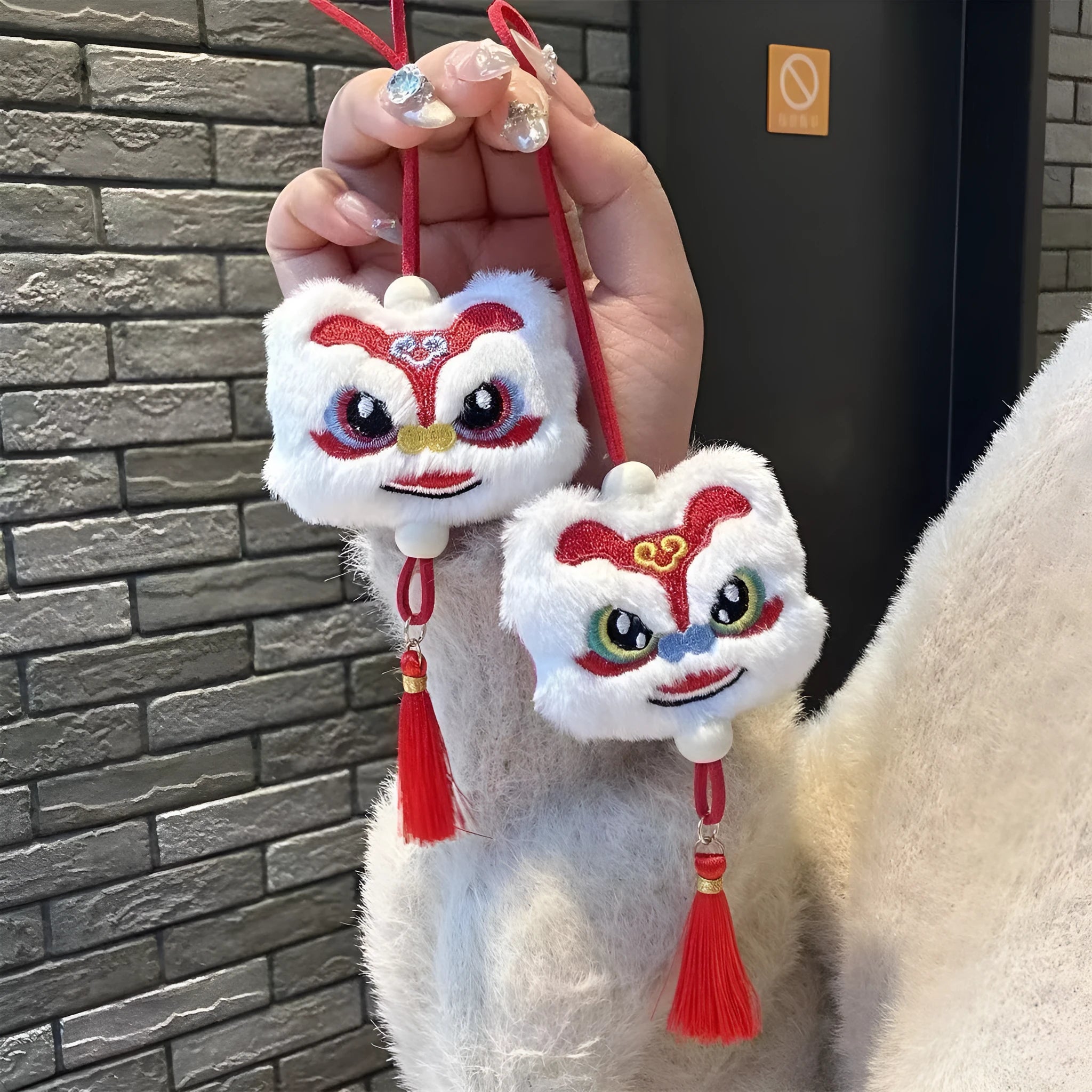 Chinese style plush lion keychain ornament with cartoon design and star stone details on blue background