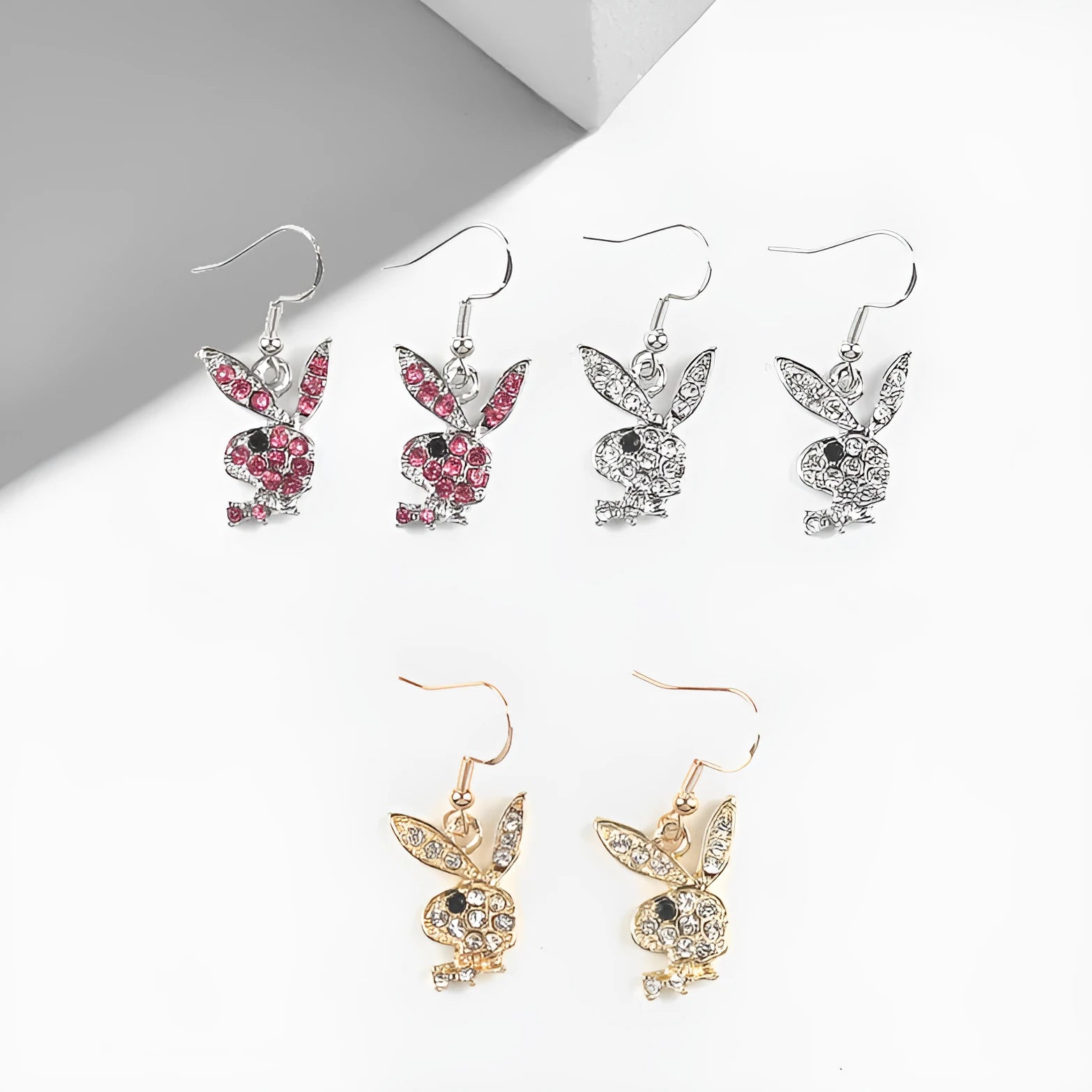 Close-up of cute rabbit stud earrings with full diamond face, in silver, pink, or gold alloy.