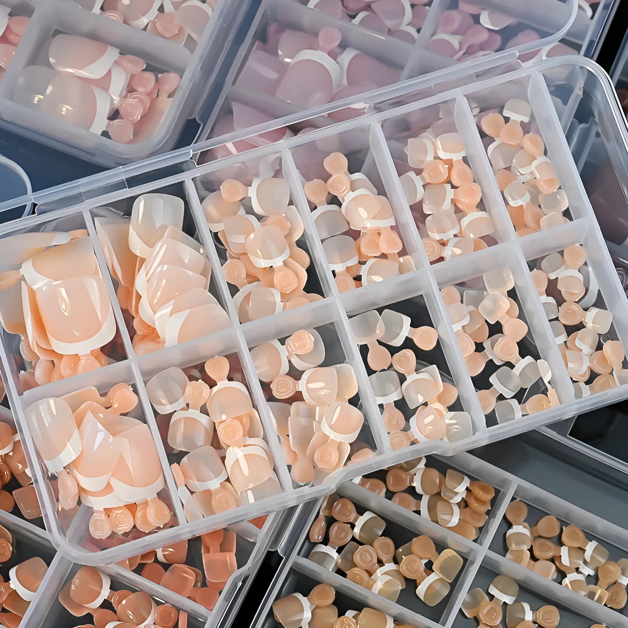 120-piece box of French white tip full square short nude nail appliqués in nine colour shades.