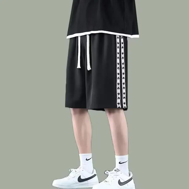 Men's black baggy track pants with micro elasticity showing loose fit sports style
