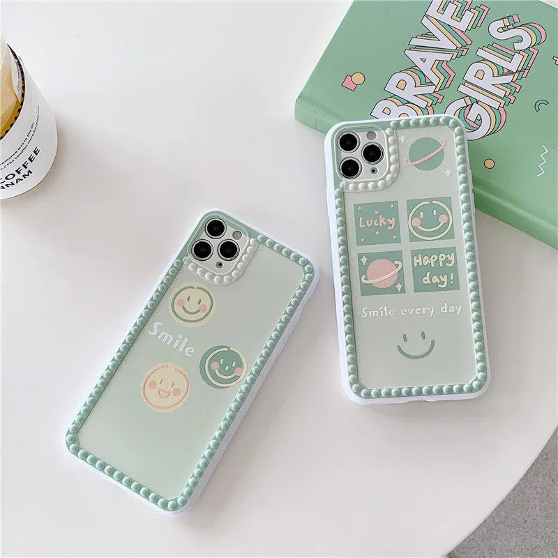 Green flexible TPU iPhone case with a geometric smiley face and polka dot frame design on the back.