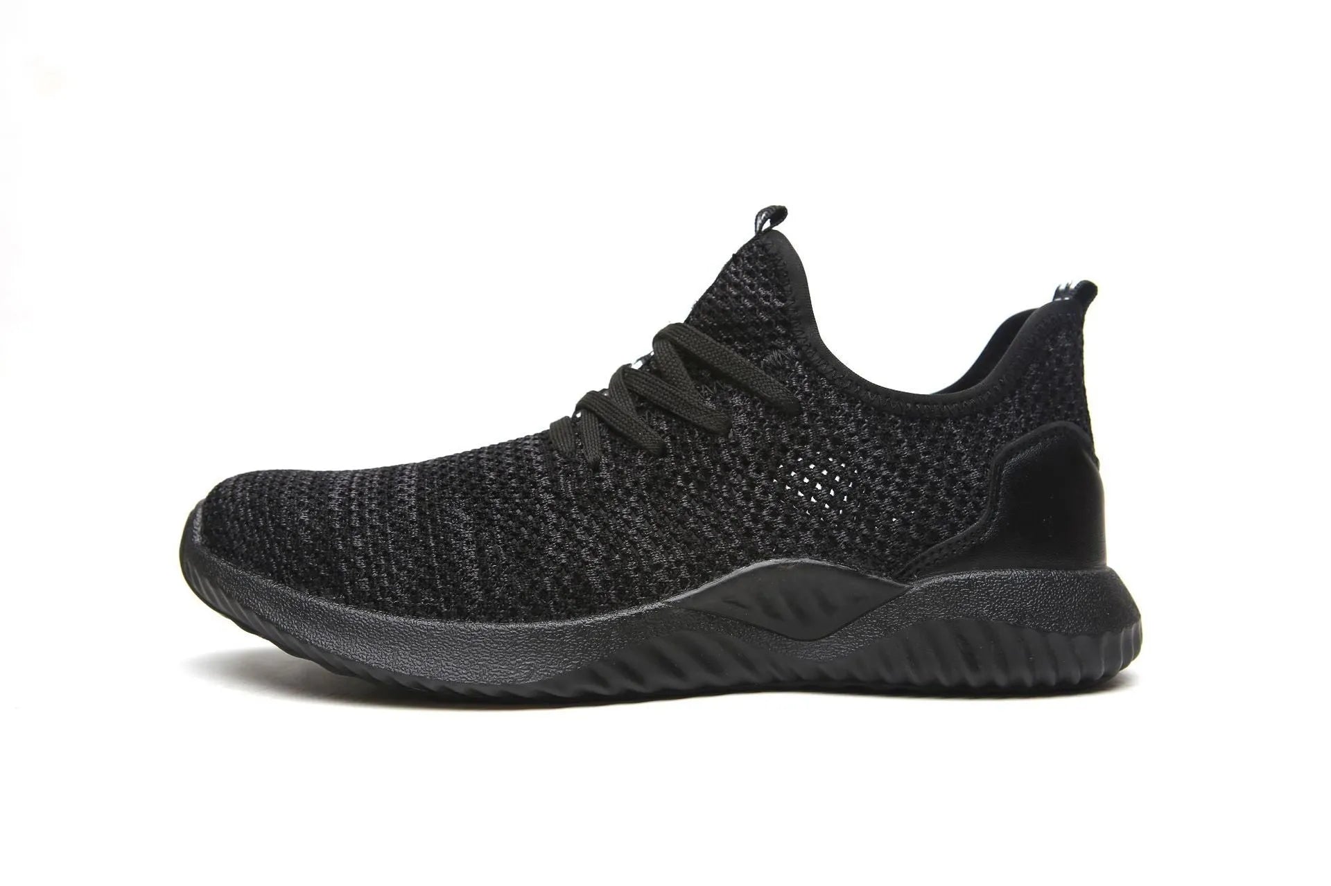 Steel toe cap safety work shoes in black with low-cut design, shown on a work site background.