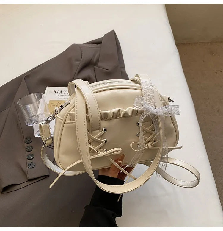 PU leather ladies shoulder handbag with phone compartment in milky white colour showing decorative stitching