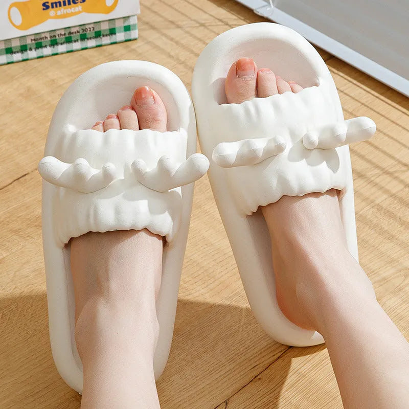 White deer horn pattern EVA flip-flop slippers with hollow-out design on a bathroom floor
