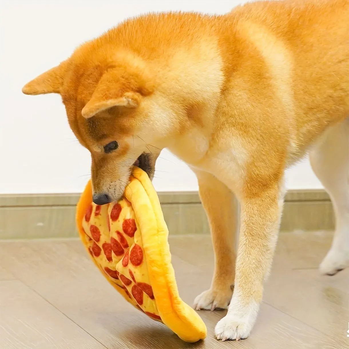 Yellow pizza slice dog chew toy with teddy bear design on top