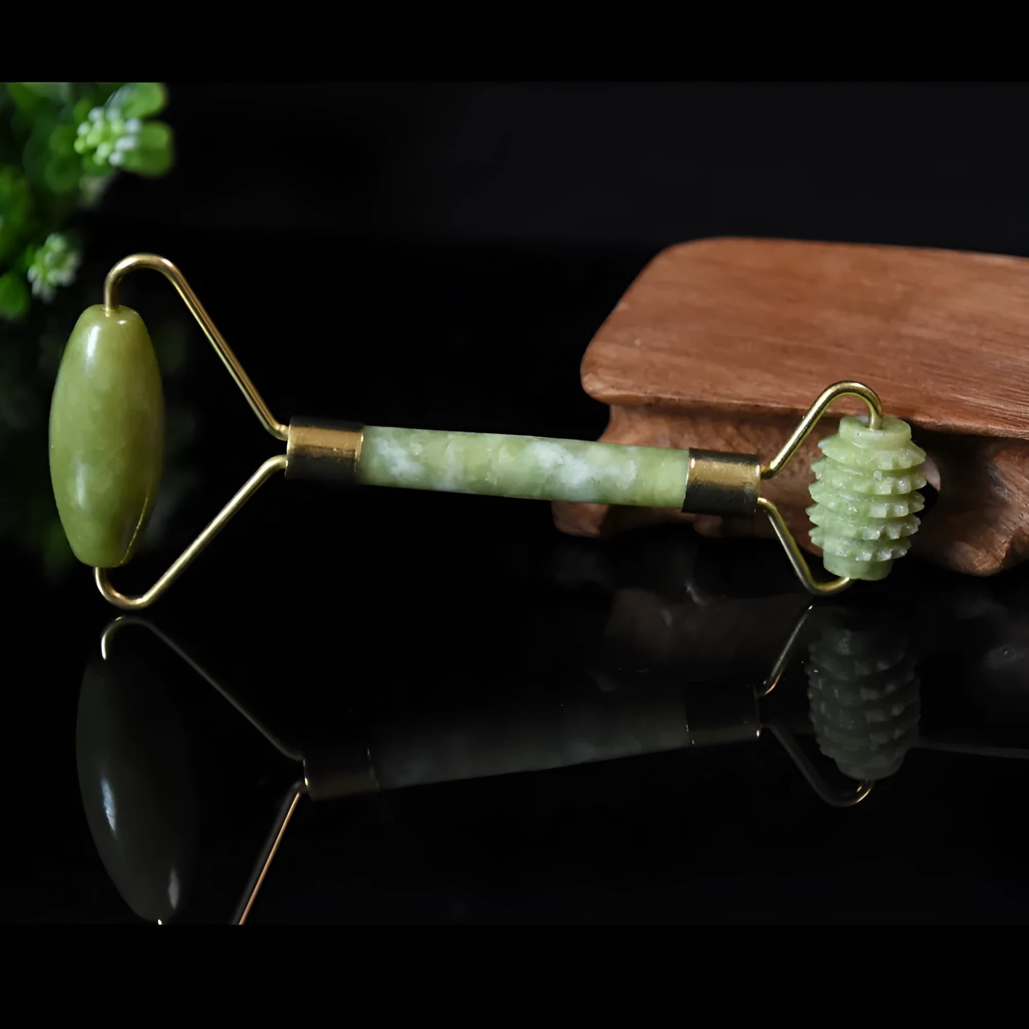 Natural green jade face massager roller and scraper set on a clean surface