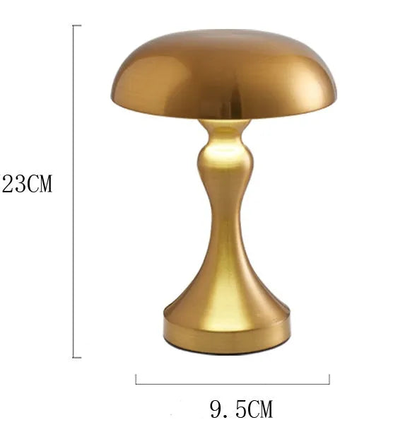 Metallic bronze USB rechargeable LED desk lamp with touch control on a wooden desk