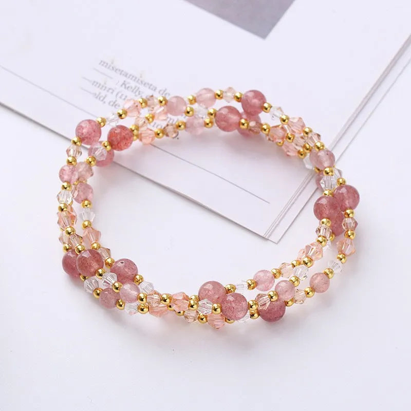 Handmade women's bracelet with tourmaline, strawberry quartz, and amethyst beads on adjustable rope