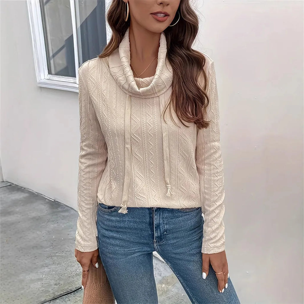 Apricot coloured women's hooded pullover sweater with long sleeves on a hanger.