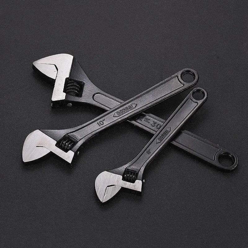 High carbon steel open-end adjustable wrench with black finish on a grey background.