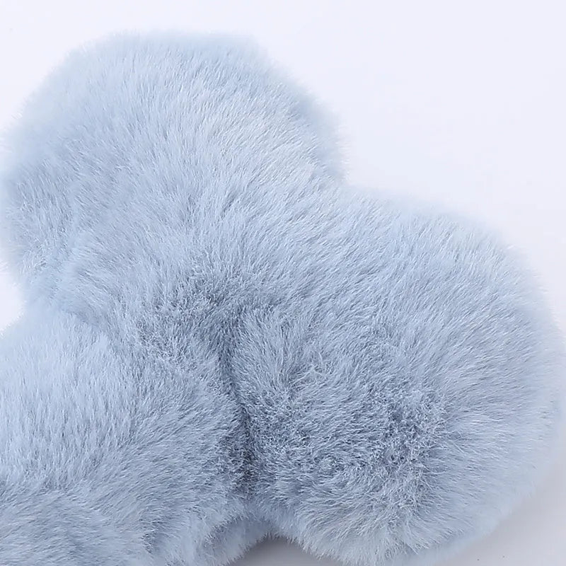 Blue plush bone-shaped dog toy with a squeaker for chew-resistant interactive play.