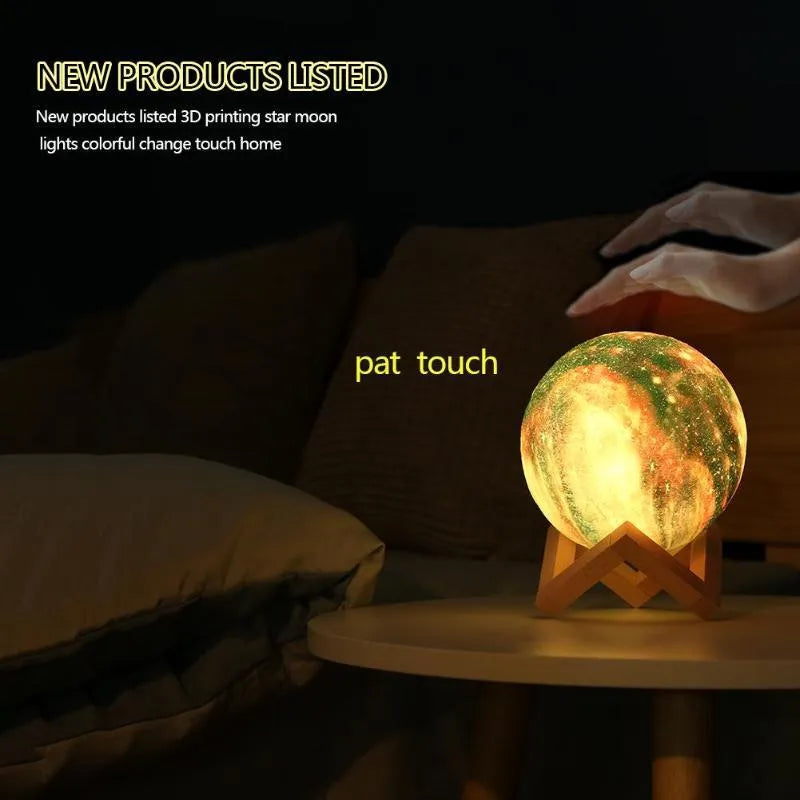 3D-printed spherical moon night light with colour-changing LED glow on a dark surface.