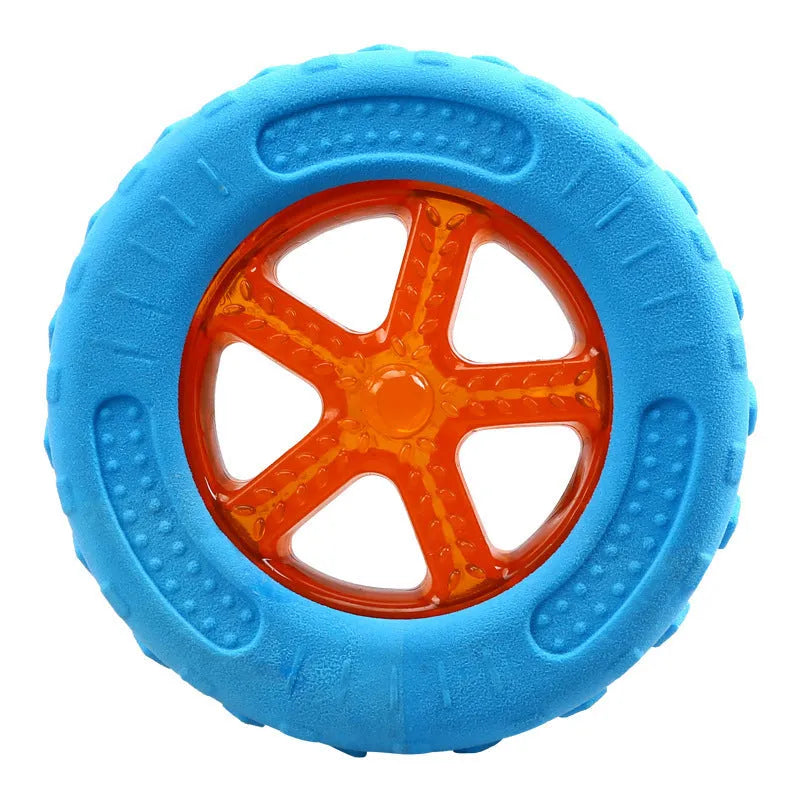 Three floating dog toys: a blue squeaky ball, a red barbell, and an orange tyre on a blue background.