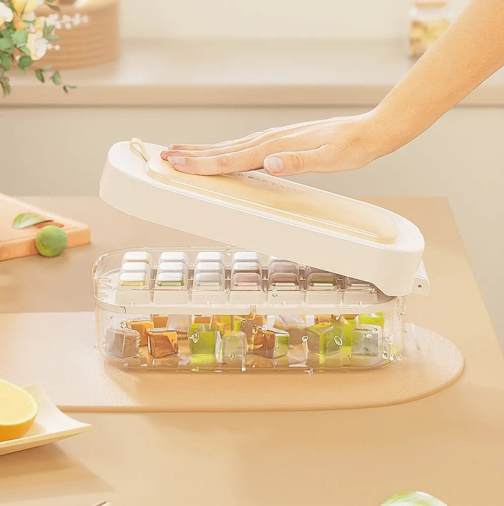 High capacity blue ice cube tray with ice grid and attached storage for the included shovel.