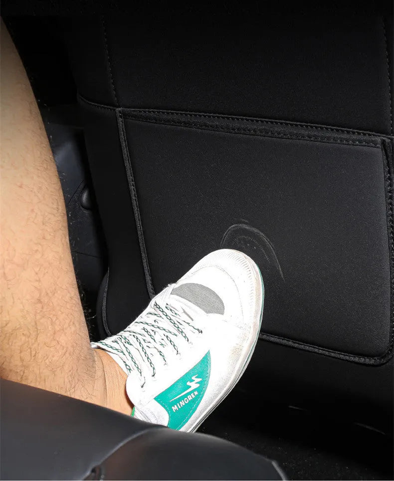 Black leather rear anti-kick pad for car seats, shown with dimensions 68cm long by 42cm wide.
