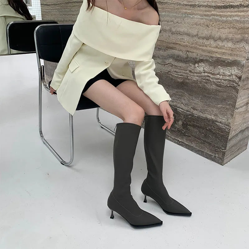Women's black pointed toe ankle boots with a stiletto heel and a back zipper fastening.