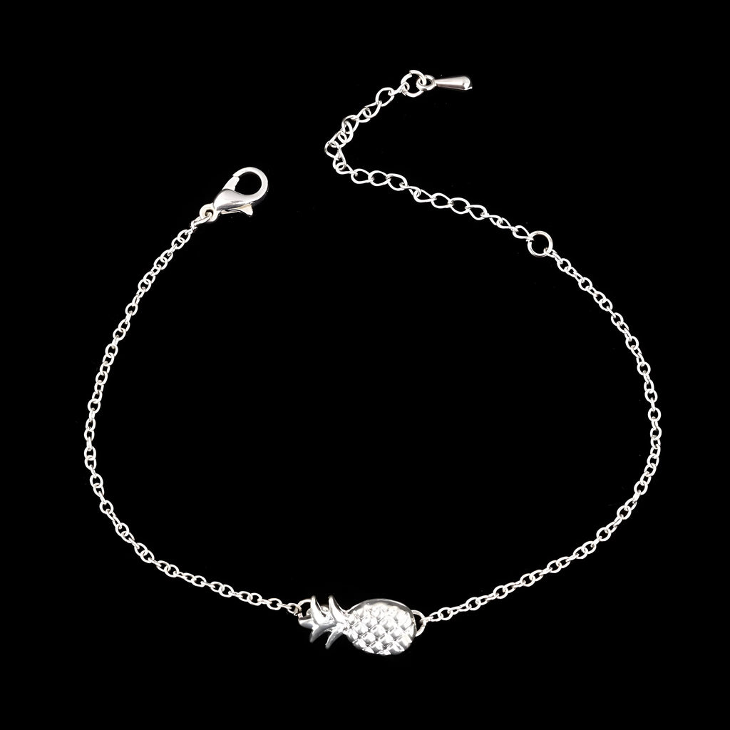 Women's alloy bracelet with a pineapple charm in gold or silver tone on a wrist.