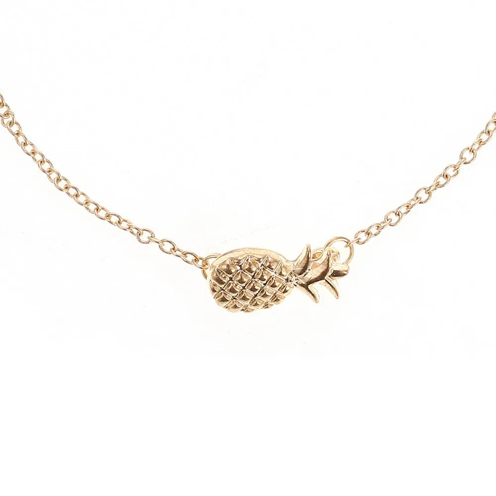 Women's alloy bracelet with a pineapple charm in gold or silver tone on a wrist.
