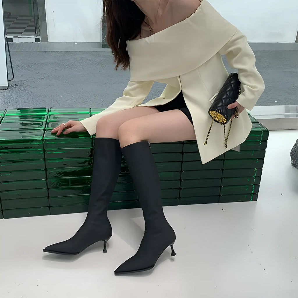 Women's black pointed toe ankle boots with a stiletto heel and a back zipper fastening.