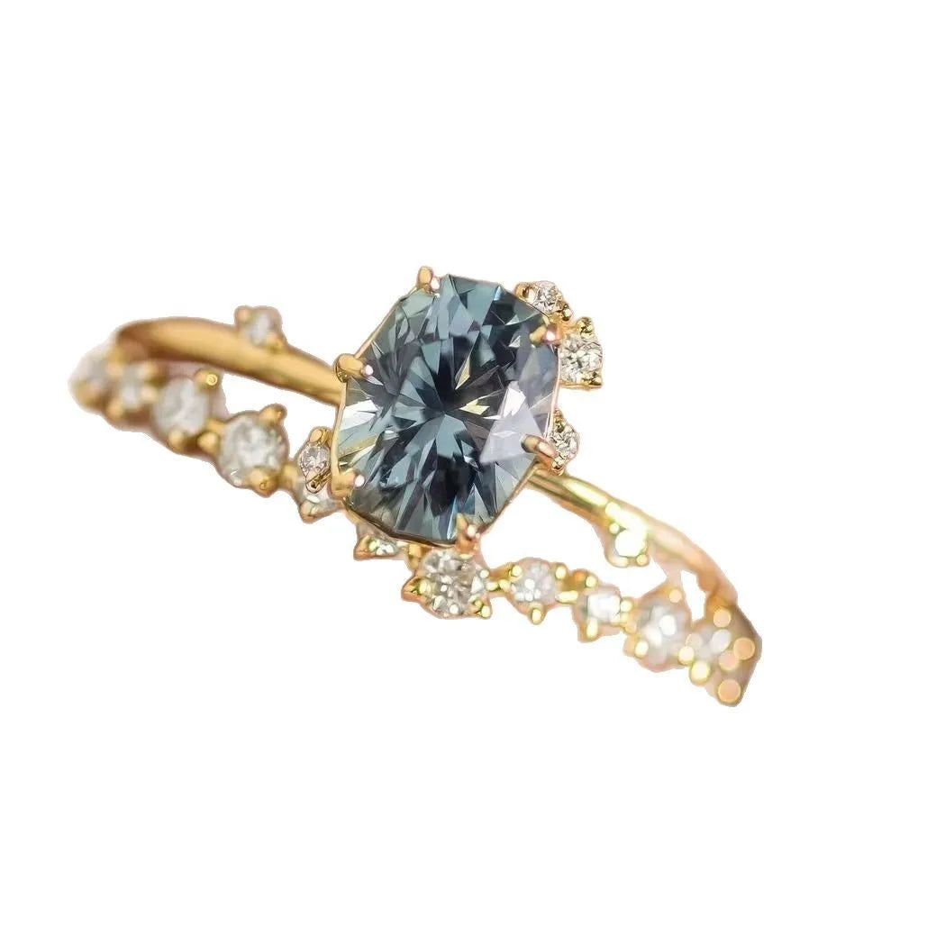 Gold plated women's ring with green zircon stone in flower shape setting, showing front and side views