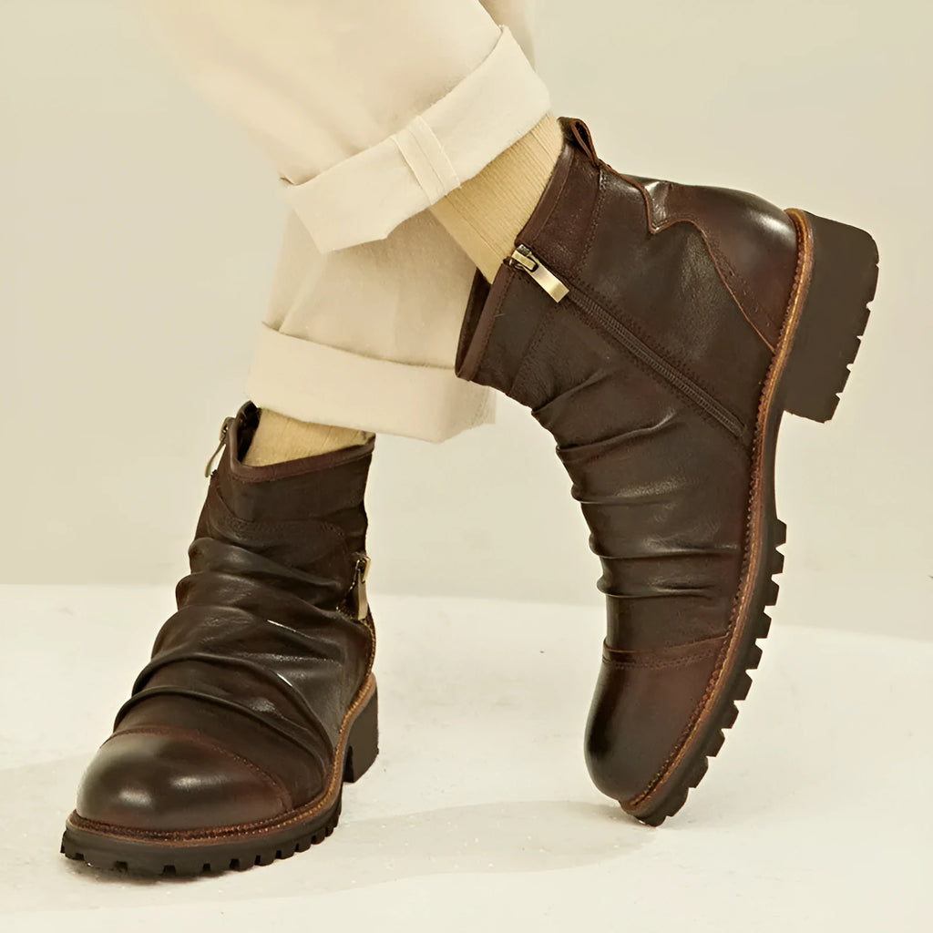 Men's black side zip cowboy boots with a round toe and mid-height horseshoe heel on a white background.