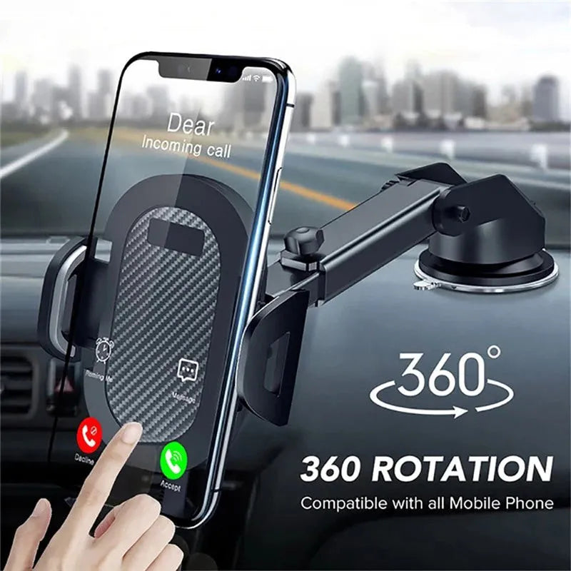 Black universal car phone holder mounted on a car dashboard holding a mobile phone