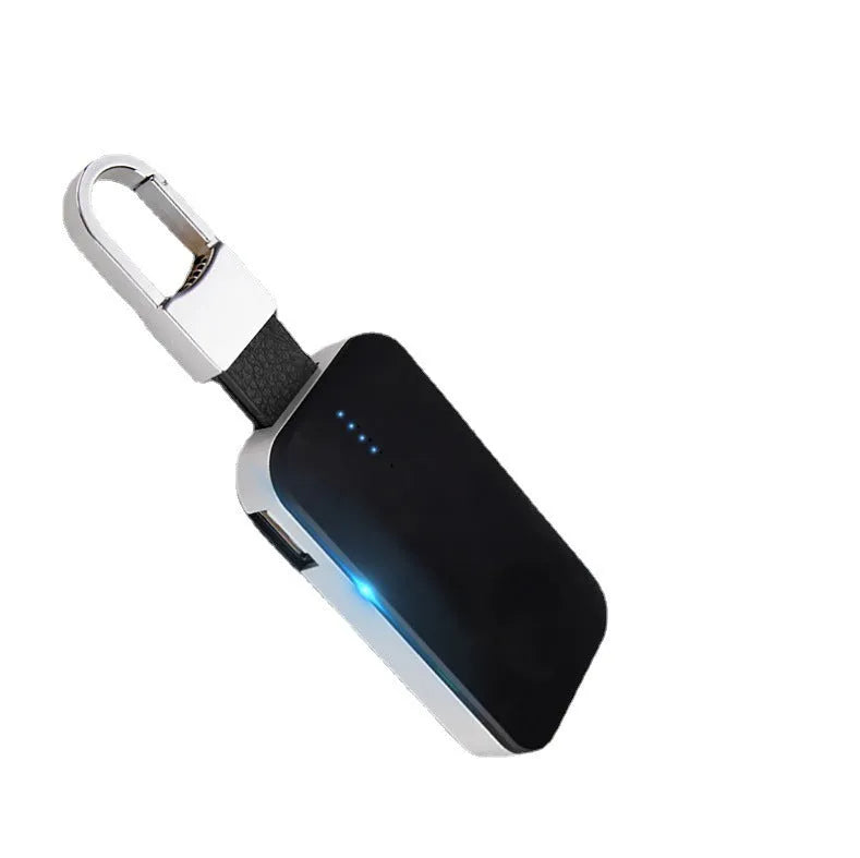 Black Apple Watch portable wireless charger keychain with keyring, shown next to an Apple Watch.