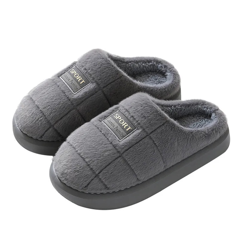 Men's grey and brown plaid rabbit hair winter slippers with a thick sole on a wooden floor.