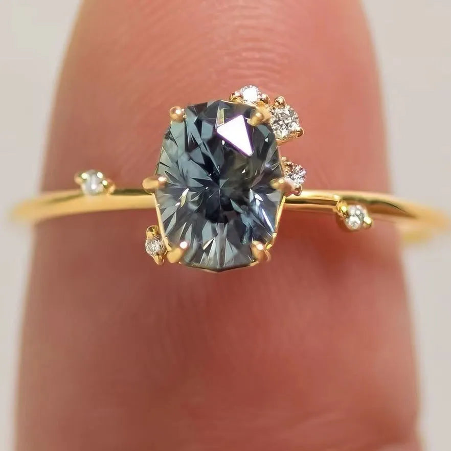 Gold plated women's ring with green zircon stone in flower shape setting, showing front and side views